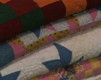 Stack of quilts Heart of Country Antique Show Nashville, Tennessee B-roll by Alan Miller