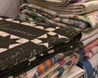 Stack of quilts Heart of Country Antique Show  Nashville, Tennessee B-roll by Alan Miller