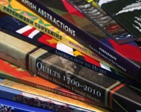 Stack of quilt exhibition books Photo by Focal Point
