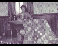 Historic photograph of woman sewing  with child peeking from behind the quilt In upcoming book by Schiffer Publishing, Atglen,  Pennsylvania; late 2012 Collection of Janet E. Finley