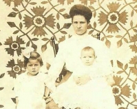 Historic photograph of a mother and her two children in  front of a quilt  In upcoming book by Janet E. Finley Schiffer Publishing, Atglen, Pennsylvania; late 2012 Collection of Janet E. Finley